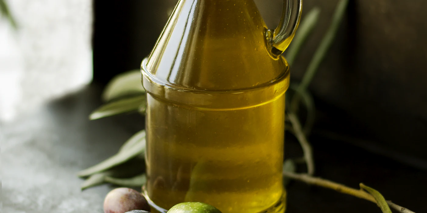 Bottle of olive oil with olive branches