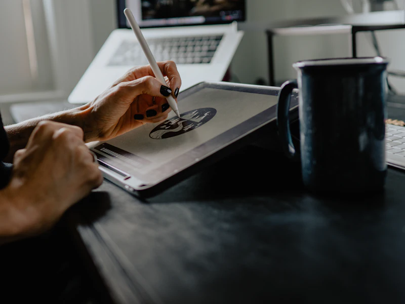 Designer drawing a logo on a tablet