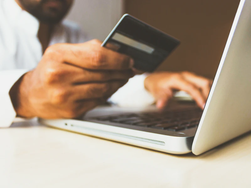 Person paying by card in an online store on their laptop